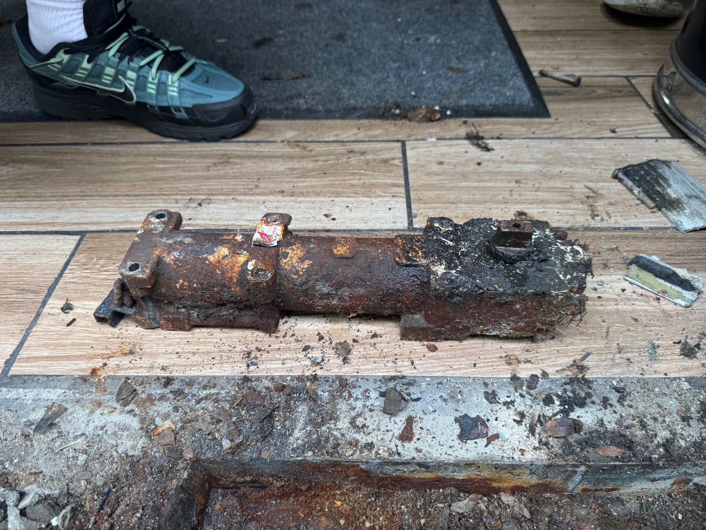 Before: the failed floor closer, rusted through