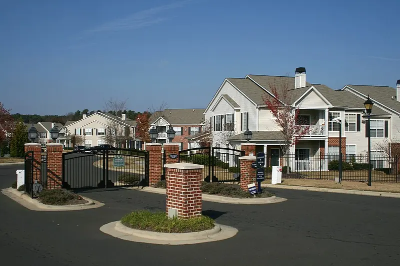 Double swing gates between brick piers at an apartment community entrance