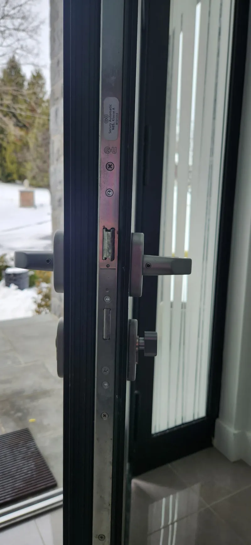 G-U multipoint lock faceplate with latch on a patio door edge