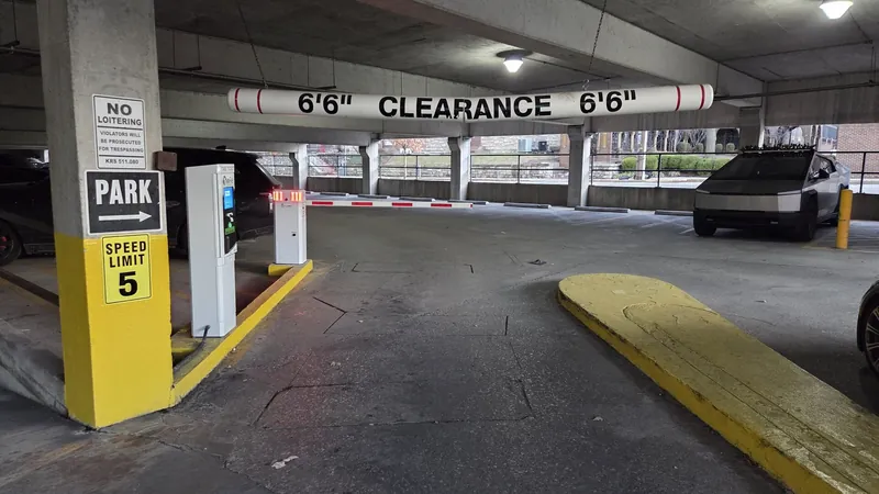 A lift-arm barrier across a commercial parking entrance