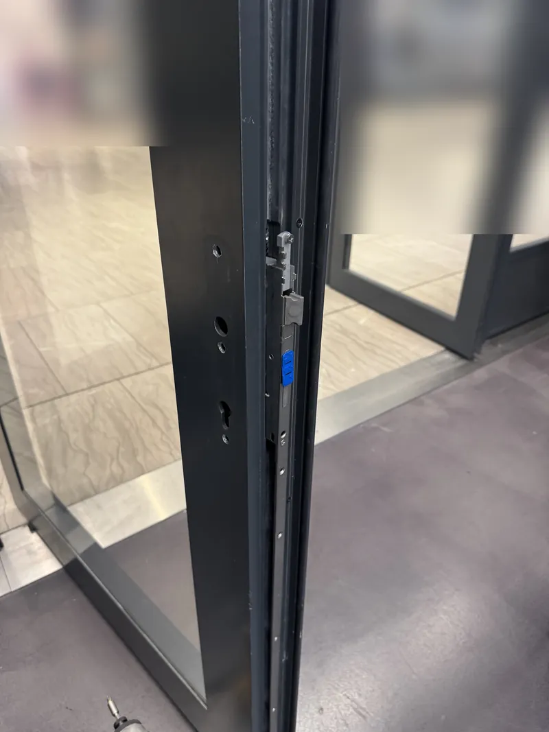 Multipoint lock faceplate on a commercial glass storefront door
